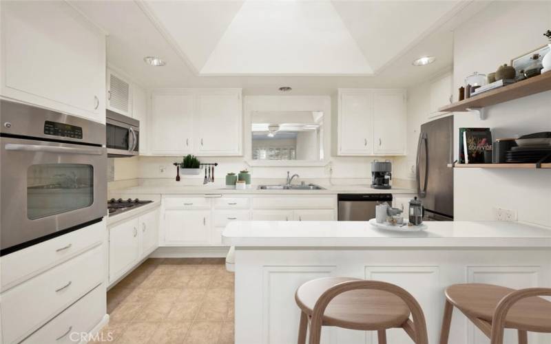 This bright kitchen offers all modern conveniences, plenty of storage and a counter for dining.  Virtual staging