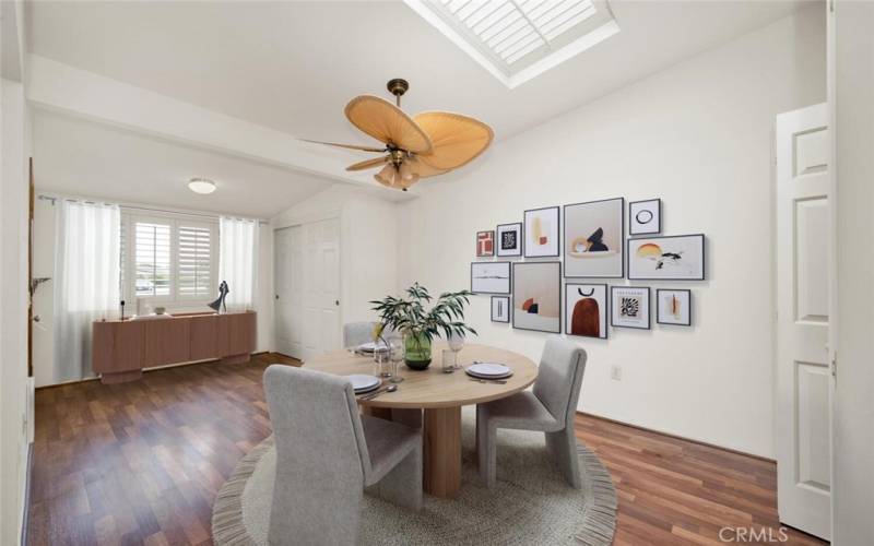 Dining area with skylight enhanced by Plantation shutters and a ceiling fan.  Virtual staging