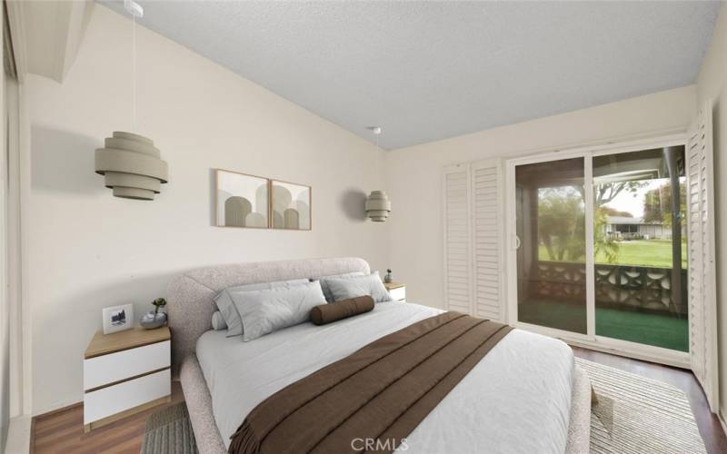 Bedroom boasts sliding doors to the spacious patio.  Plantation shutters offer privacy to this bedroom. Virtual staging