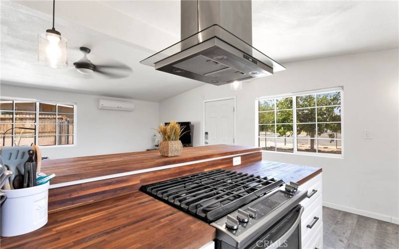 Wow this kitchen is awesome. Authentic butcher block counters and stainless appliances. spacious and open to the living room with high ceilings give this home a wonderful greatroom feel.