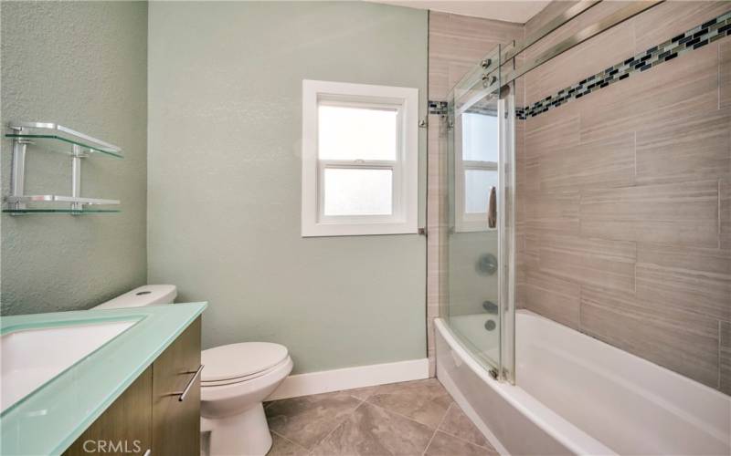 Primary bathroom with shower over tub.