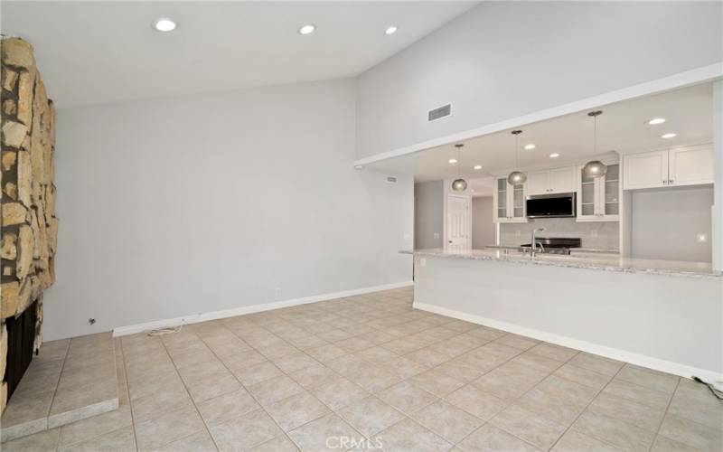 The upgraded kitchen opens to the large separate family room that features high ceilings, recessed lighting, a fireplace