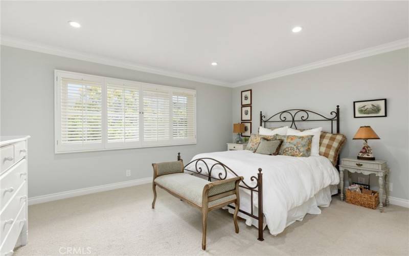 Guest Bedroom with Plantation Shutters that Overlook the Front Private Patio