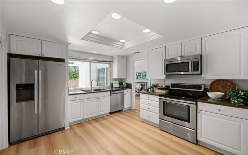 Sizeable kitchen has recessed lighting and stainless steel appliances