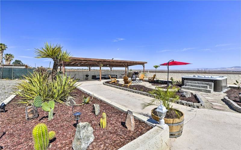 Backyard pergola seating area. Hot tub with incredible Desert landscape views.