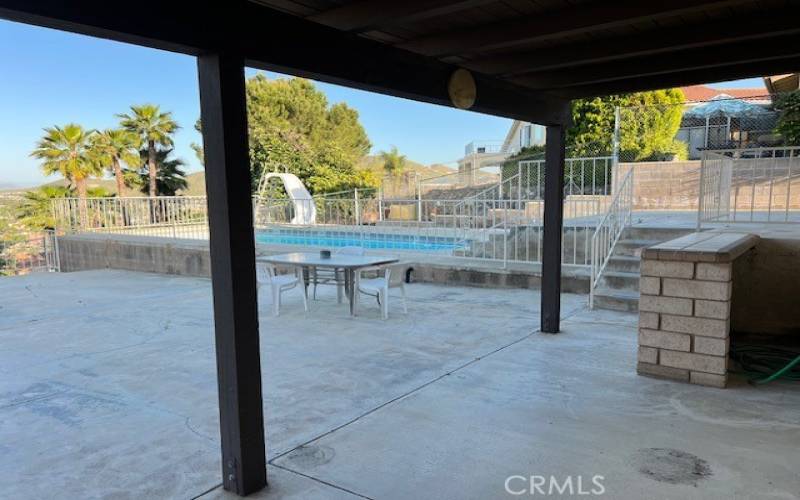 View of backyard and pool from dining room slider