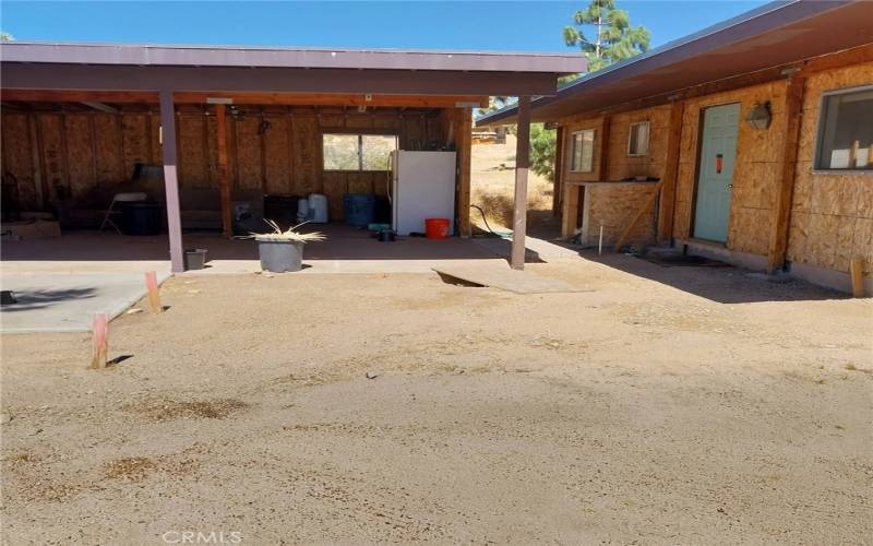 Front entrance of house and Workshed/Carport. Gutted. Architectural plans to connect the two.