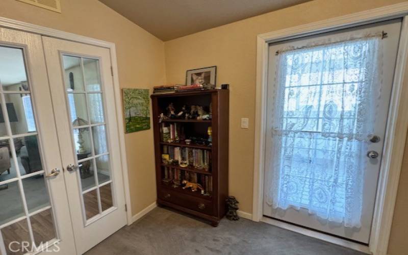 French doors lead from living room to den, and door out to the sun porch.