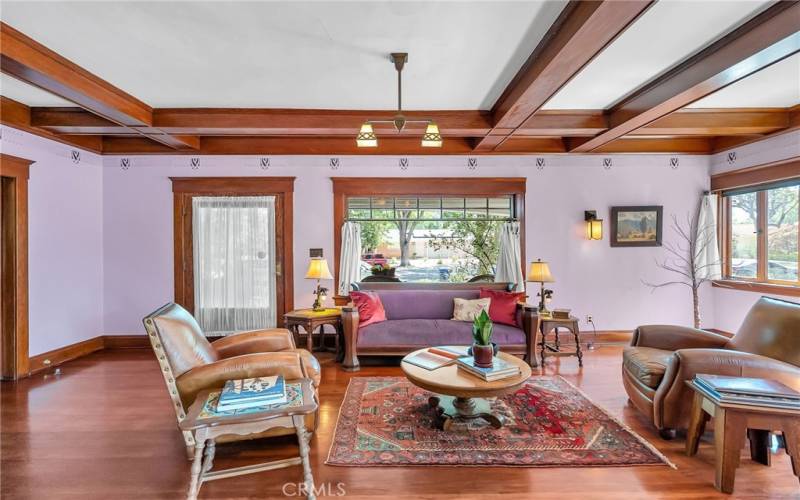 Entry with large window framing the tree lined street outside.