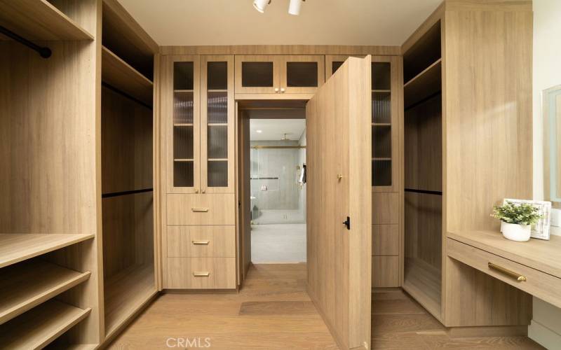 Custom made closet in master bedroom opens into master bathroom
