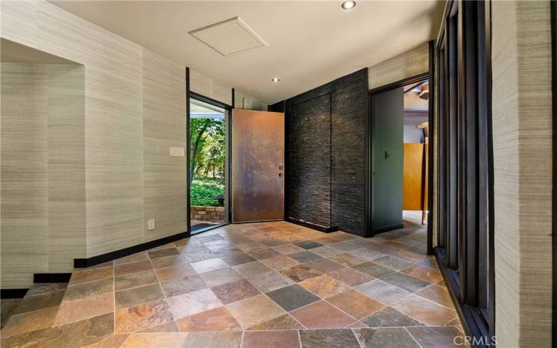 Stepping inside you are greeted by slate tiled floors.