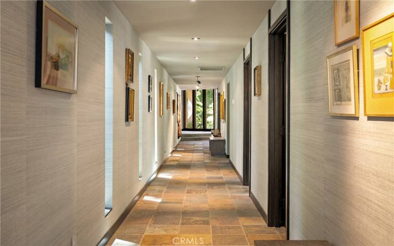 The hallway leading back to the two guest bedrooms and main bathroom is oversized and is the perfect location to display your artwork.