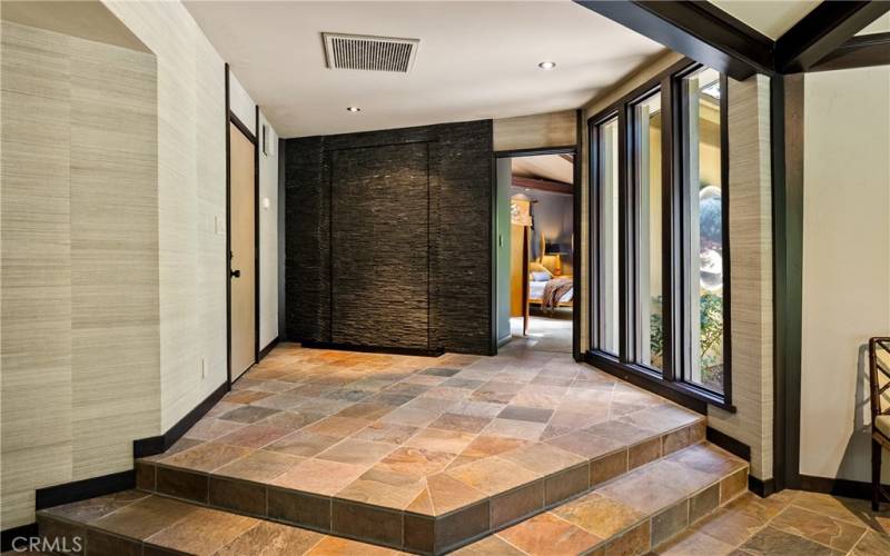 In the entryway there is a one-of-a-kind rock waterwall.