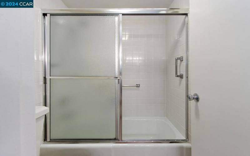 Shower over tub in water closet of Primary Bath
