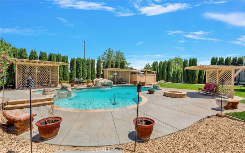 Several shade cabanas surround the pool.