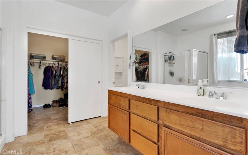 Primary en suite has dual sink vanity, separate oval soaking tub, large shower stall and private water closet.