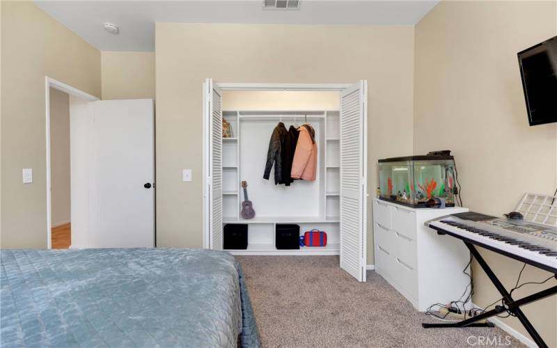 Bedroom 1 of 5 with custom closet storage configuration. New paint and carpet.