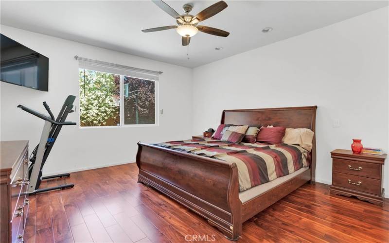 Upgraded wood flooring in the bedroom area.