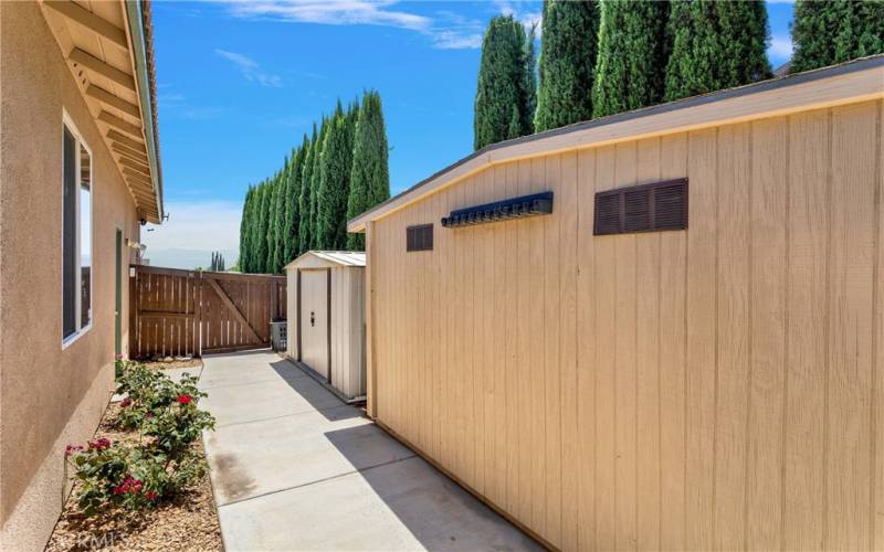 Two large storage sheds for pool toys, yard tools, and holiday storage.