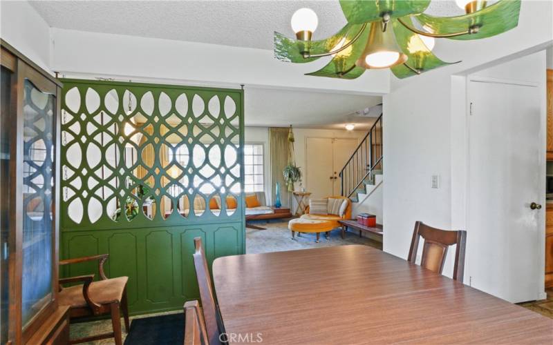 Dining room conveniently next to kitchen - looks at that lighting fixture!