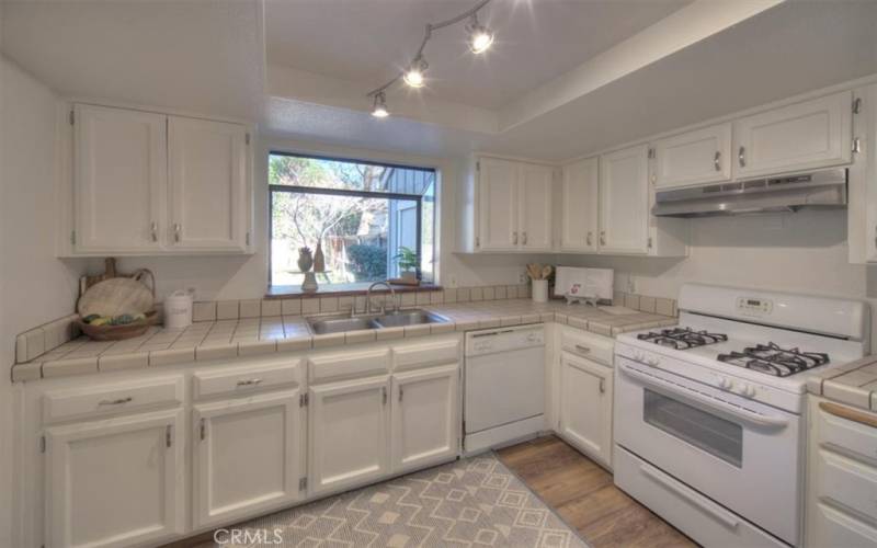 Gas range, brand new hood vent, and a newer refrigerator are included