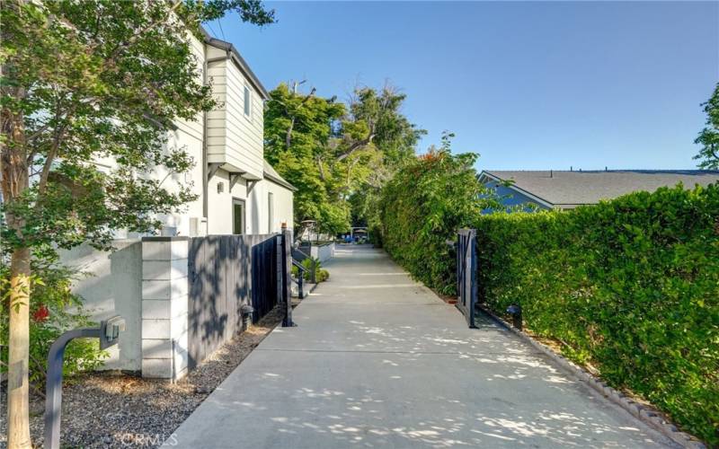 Extra long driveway entry with plenty of parking both outside and behind the automated gates