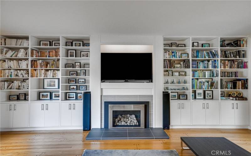 Wall-to-wall bookcases and Direct-Vent fireplace with unique venting system that consists of two separate pipes - one for intake and one for exhaust. The intake pipe draws fresh air from the outdoors, which is used for combustion, while the exhaust pipe expels the combustion gases and byproducts outside
