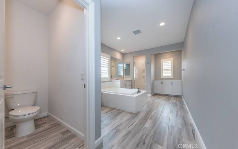 huge primary bedroom's ensuite (4th) bathroom boasts separate soaking tub, shower, and storage areas