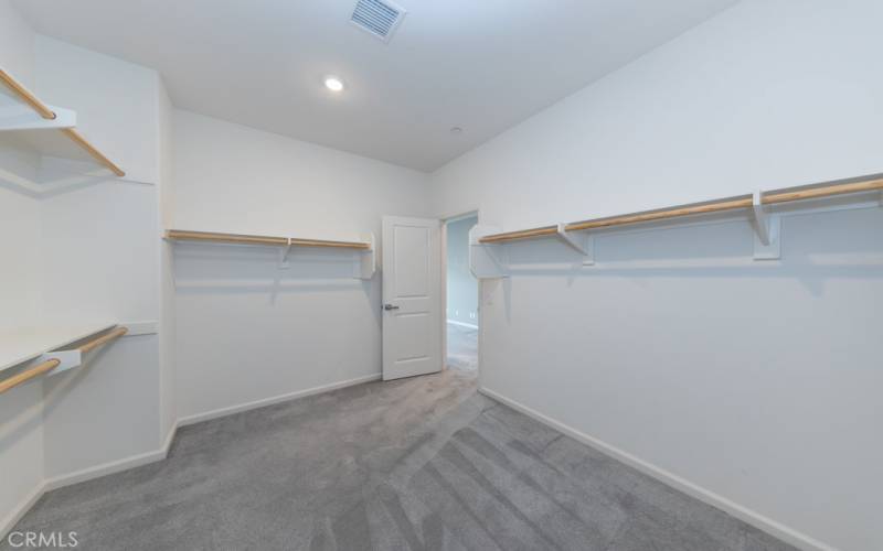 spacious primary bedroom closet is located just inside primary suite on left, opposite primary (4th) ensuite bathroom