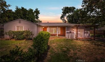 Evening Front Yard Shot.Very Sturdy Stucco and Brick Construction with At active Wisteria Vines located on a larg quarter acre, mostly fenced-in lot. 1532 Sqft 3/2 hom is also commercially zoned to run your own business from home!