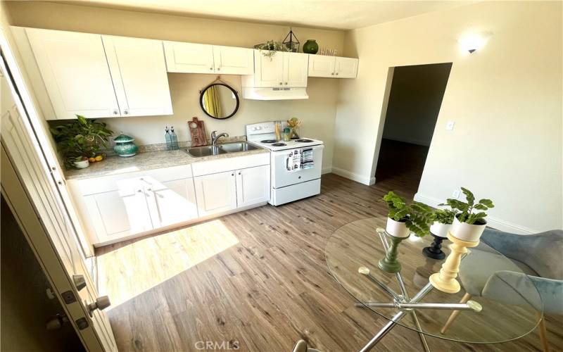 Eat in kitchen with new electric range and access to backyard