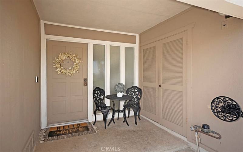 This inviting front porch area, complete with a handy storage closet.