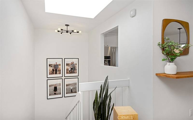 The skylight floods the room with an abundance of natural light, creating a bright and airy atmosphere throughout.
