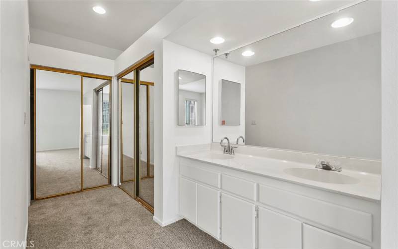 primary bathroom with dual mirrored closets