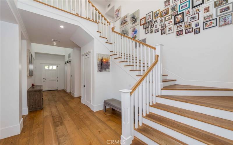 Wraparound hardwood staircase - towering ceilings