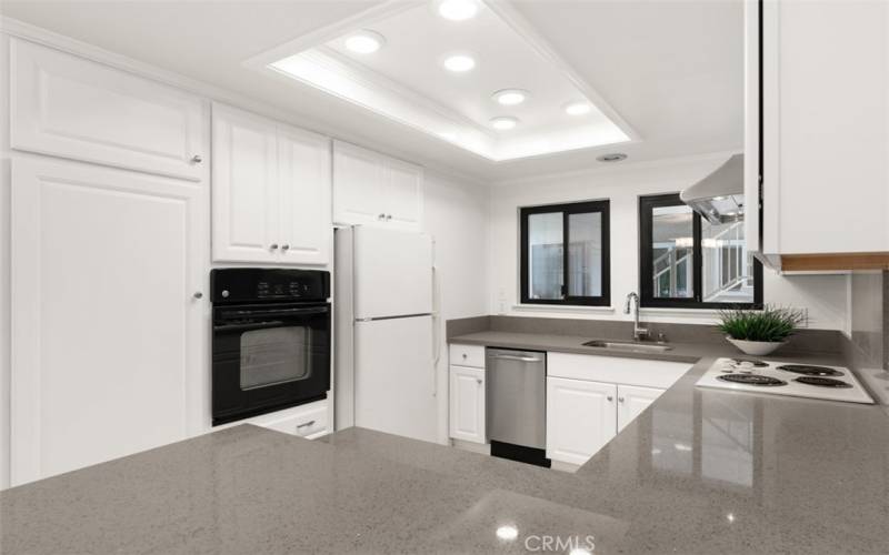 Eurostyle white cabinetry and Quartz counters.  Hoa Maintained oven, cooktop and refrigerator.