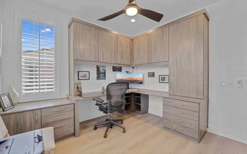 The downstairs secondary bedroom is the perfect office, complete with custom built-in's/desk