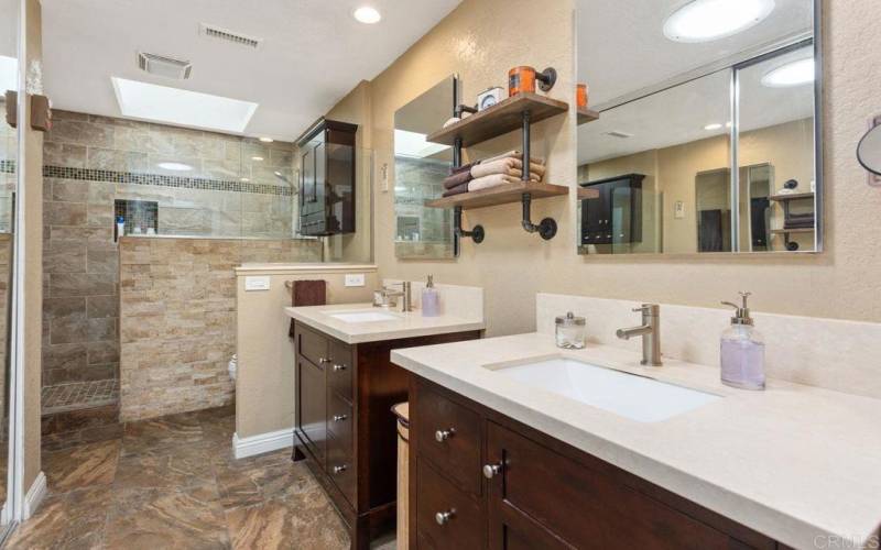 Walk in custom shower with skylight & double sinks with solar tube.  Walk in closet.