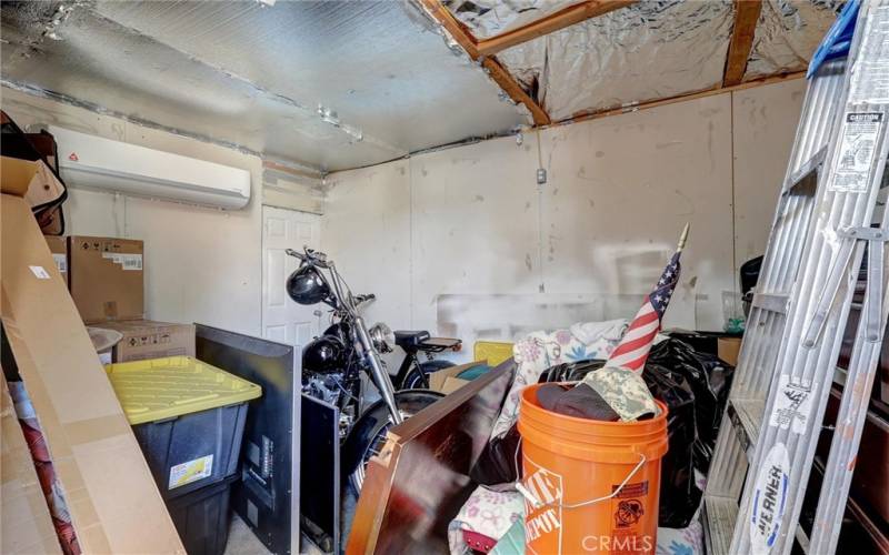 The garage has been converted into an office with A/C, currently used as storage.