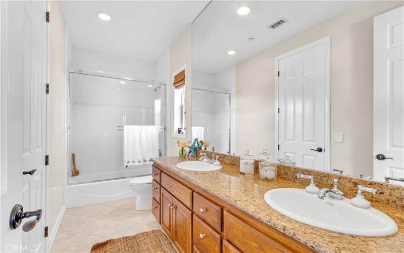 Jack and Jill bathroom with double sinks for convenience.