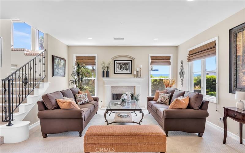 The living room is comfortable and inviting with high ceilings and ocean views.
