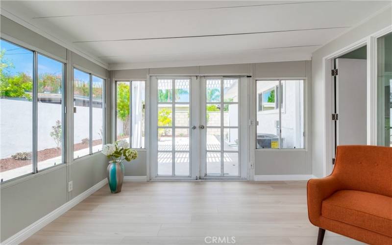 You're sure to love this permitted enclosed patio room that has been made even better with a new mini-split AC, gorgeous flooring, and modern lighting.