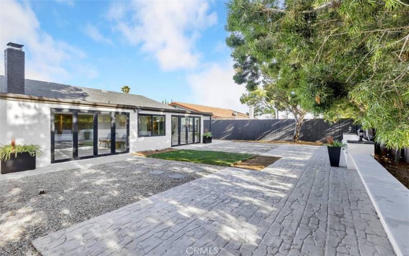 backyard stamp concrete with view of sunroom