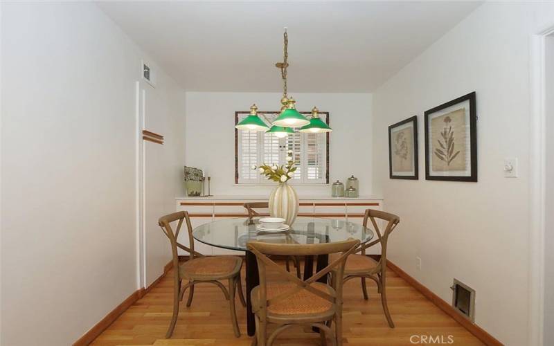 Breakfast nook by the kitchen with lovely wood floors and freshly painted walls.
