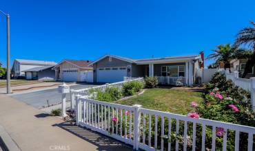 Darling curb appeal with white picket fence and lots of roses!