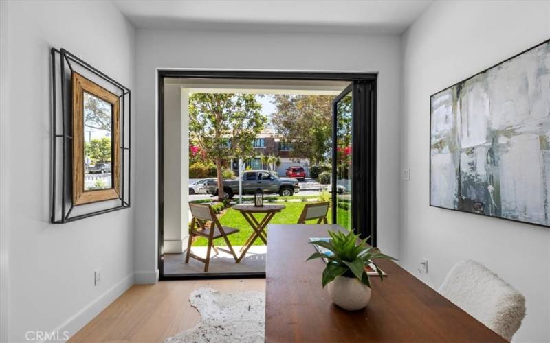 8' folding doors lead to covered porch and front yard