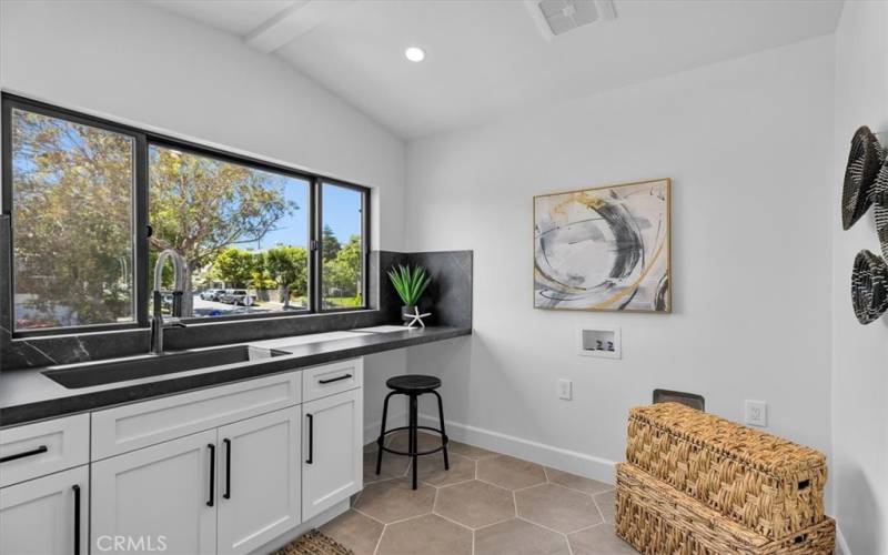 Dedicated laundry room adjacent to reading/play area upstairs