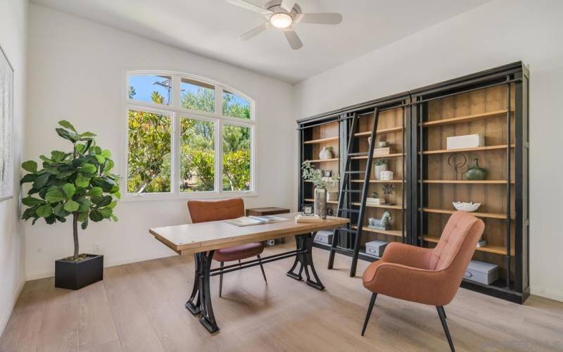 Private office at the front of the home with floor-to-ceiling bookshelves.
