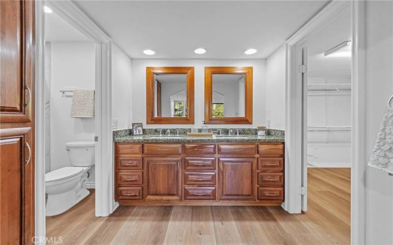 Master bathroom has custom vanity. The mirror open and act as a medicine cabinet.