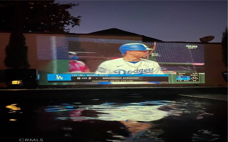 The owners projector shows on the pool wall. Imagine pool party movie nights here this summer!